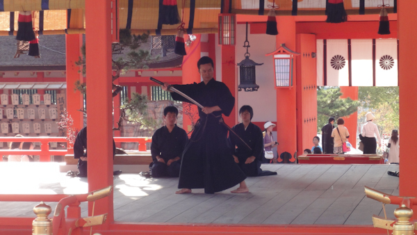 a man performs a sword demonstration inside the buiding